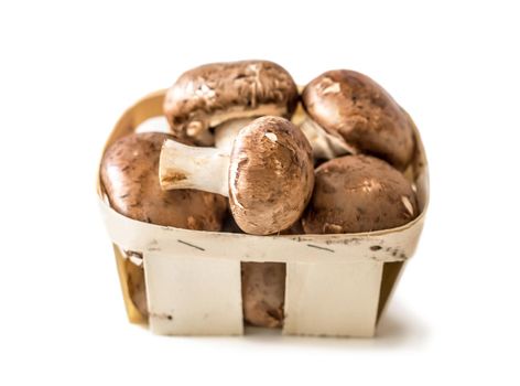 Mushrooms in a basket isolated on a white background.