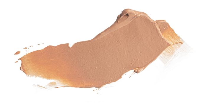 Smudged stain of a cream foundation isolated on white