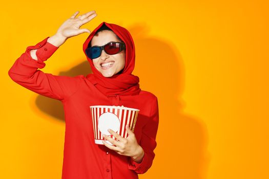 woman in red hijab popcorn entertainment cinema ethnicity model