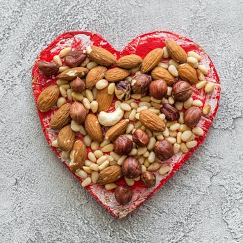 heart with nuts on a gray background