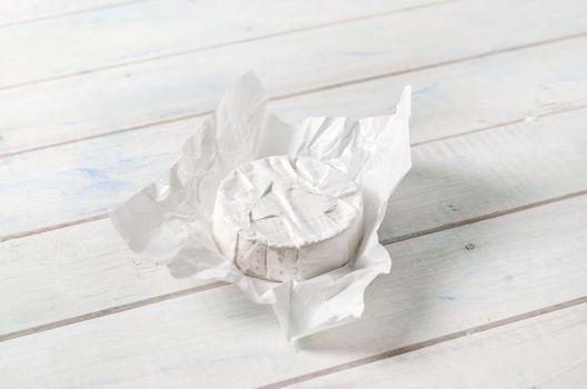 camembert cheese wrapped in white paper