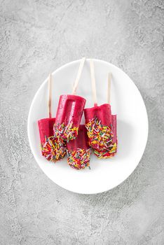 sprinkled popsicles made with red currant, raspberry, topview