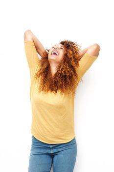 carefree young woman laughing with hands behind head