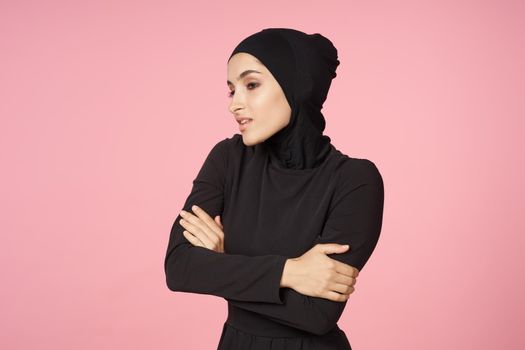 cheerful muslim woman black hijab posing hand gesture pink background