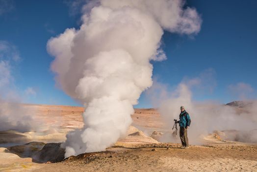 Man standing by the steaming gather in Bolivia