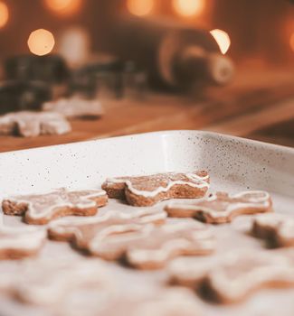 Christmas baking and cooking recipe concept. Food ingredients and preparation process of traditional homemade gingerbread men biscuits in the kitchen at home during winter holidays