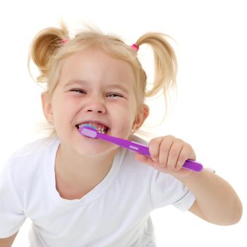 Cute little girl brushing her teeth. She uses a toothbrush. The concept of healthy teeth, hygiene, dentistry. Isolated on white background.