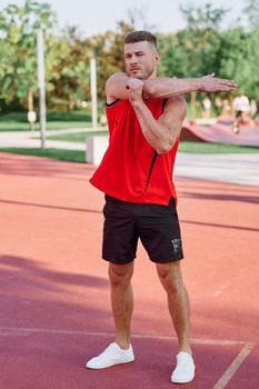 athletic man doing exercises outdoors sports field exercise
