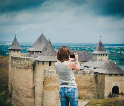 girl taking a photo of Khotyn Fortress