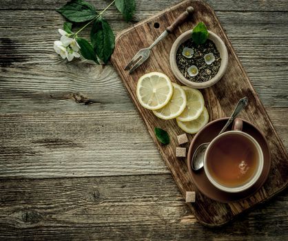 jasmine tea with lemon in brown cup, copyspace