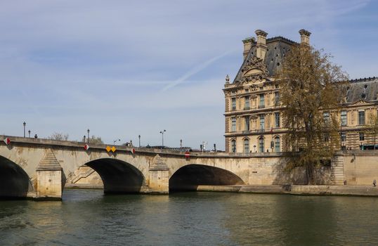 One of the oldest bridge ( Pont Royal ) across Seine River and beautiful historic buildings of Paris France. April 2019