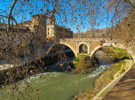 Oldest Roman bridge (Ponte Fabricio) on the Tiber river. Rome, Italy - January 2012