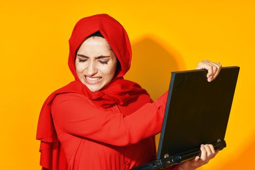 woman in red hijab with laptop in hands technology emotions ethnicity model