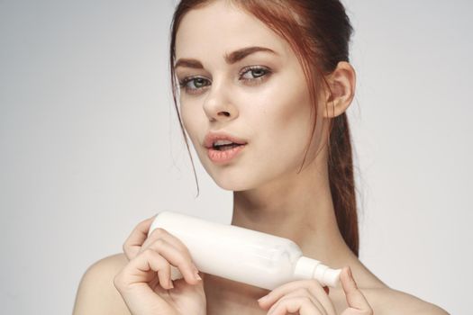 woman with bare shoulders cosmetics procedures skin care cream
