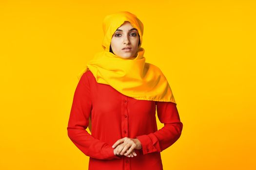 muslim woman wearing yellow hijab posing ethnicity yellow background