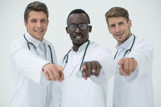 multinational group of doctors pointing at you
