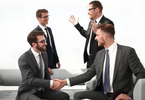 business partners shaking hands after signing the contract