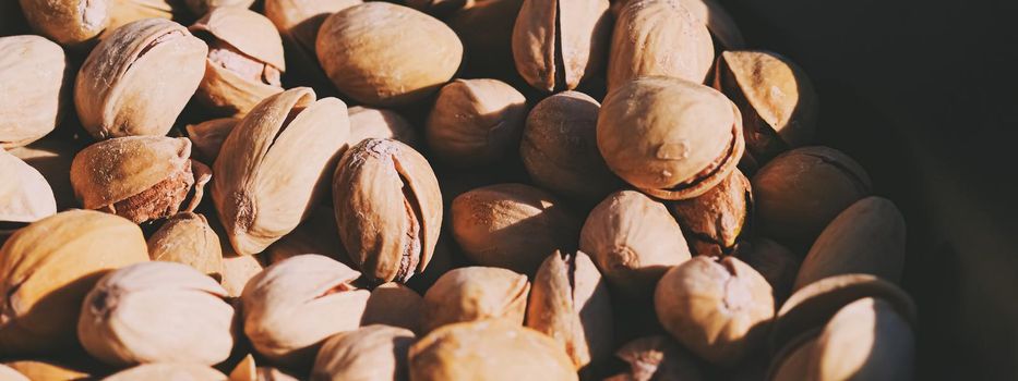 Organic pistachios in the sun, healthy food and snack background