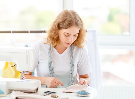 Dressmaker sewing new design by hands