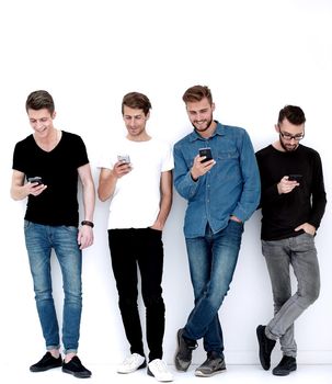 in full growth.group of friends with smartphones.communication concept