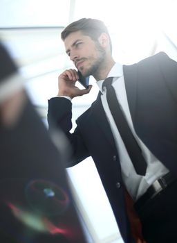 Below view of businessman in suit with cellular phone