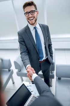 close up.smiling businessman shaking hands with financial lawyer