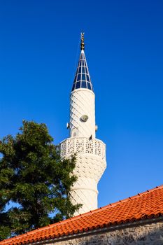 Mosque Minaret on a background of blue sky in Bitez, Bodrum, Turkey