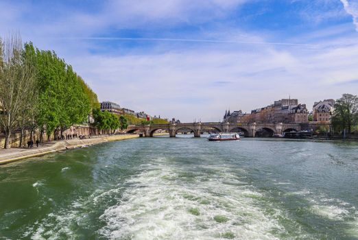 The oldest standing bridge ( Pont Neuf ) across the River Seine, boats and historic buildings of Paris France. April 2019