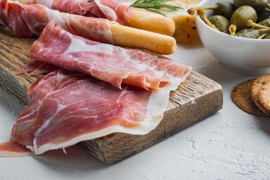 Prosciutto and herbs, on white background