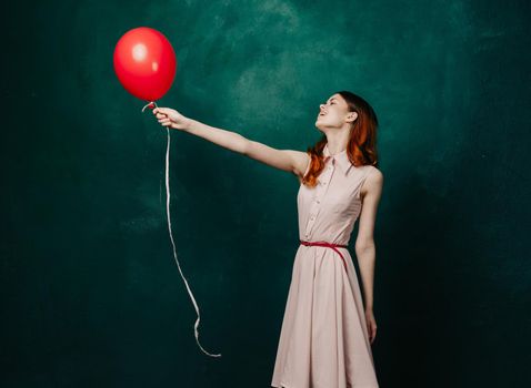 woman with red balloon celebration birthday green background