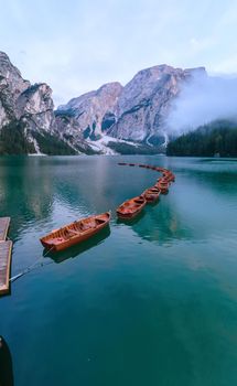 Beautiful landscape of Braies Lake Lago di Braies romantic place with wooden bridge and boats on the alpine lake, Alps Mountains, Dolomites, Italy, Europe