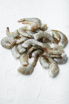 Raw shell on king prawns, on white stone surface, with copy space for text