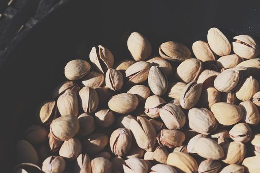 Organic pistachios in the sun, healthy food and snack background