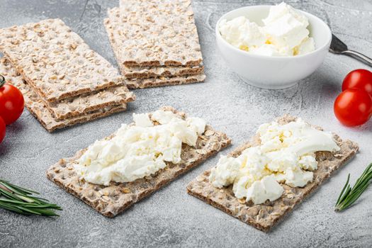 Crisp breads with butter, on gray stone table background