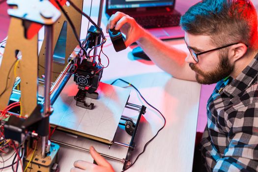 A student man print prototype on 3D printer