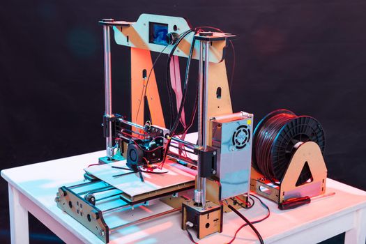 3d printer working and printing plastic prototype