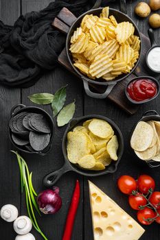 Variation different potato chips with Cheese and Onion, on black wooden background, top view flat lay