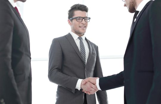 close up.young businessman shaking hands with investor