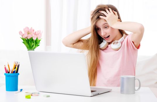 Girl shouting in front of computer