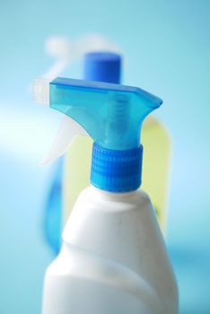 disinfect spray bottles on blue background