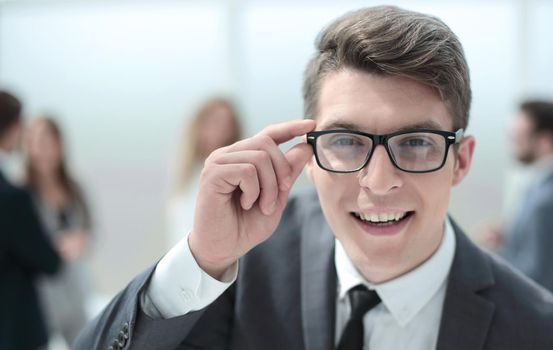 smiling young businessman looking at you attentively