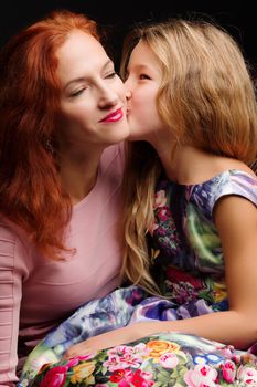 mother and little daughter gently embrace