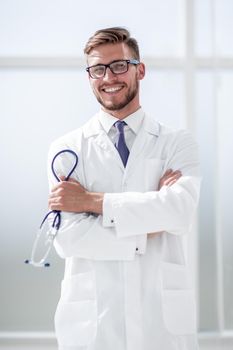 portrait of a smiling middle aged doctor in lab coat with stethoscope