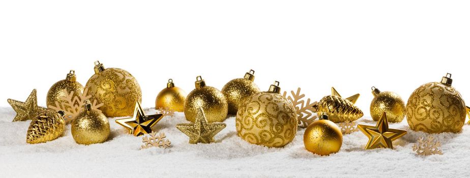 Christmas golden baubles on snow