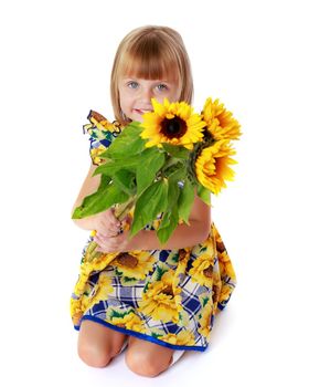 Little girl with flowers of sunflower.