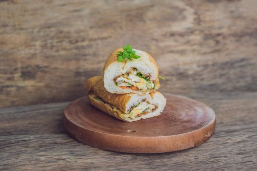 A delicious Vietnamese Bahn Mi sandwich on a wooden background