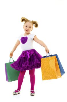 Little girl with multi-colored bags in their hands.