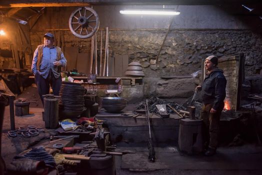 portrait of two generations traditional blacksmith