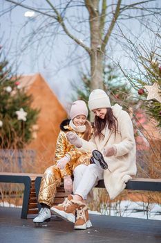 Family winter sport. Mother and daughter on winter day