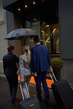business people couple entering  hotel